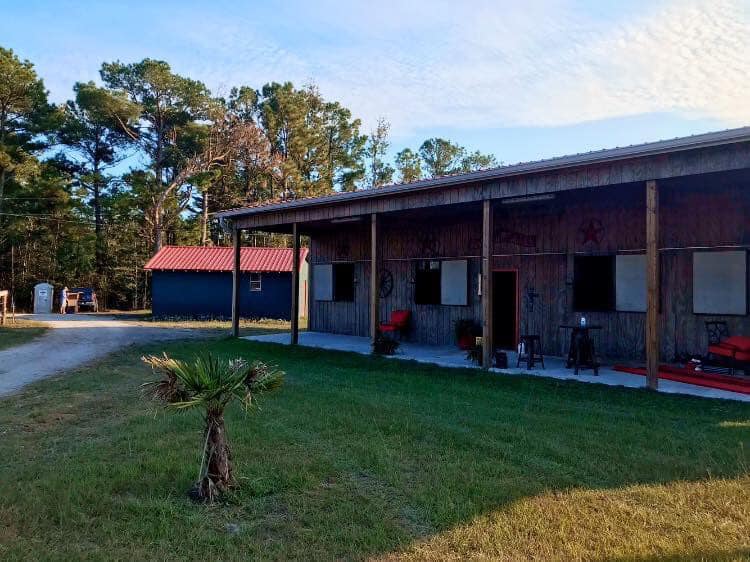 Barn front with red roof and lawn chairs