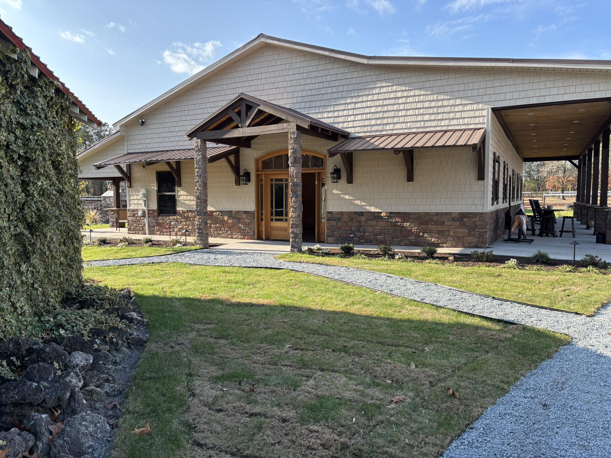 The barn exterior with covered porch and seating