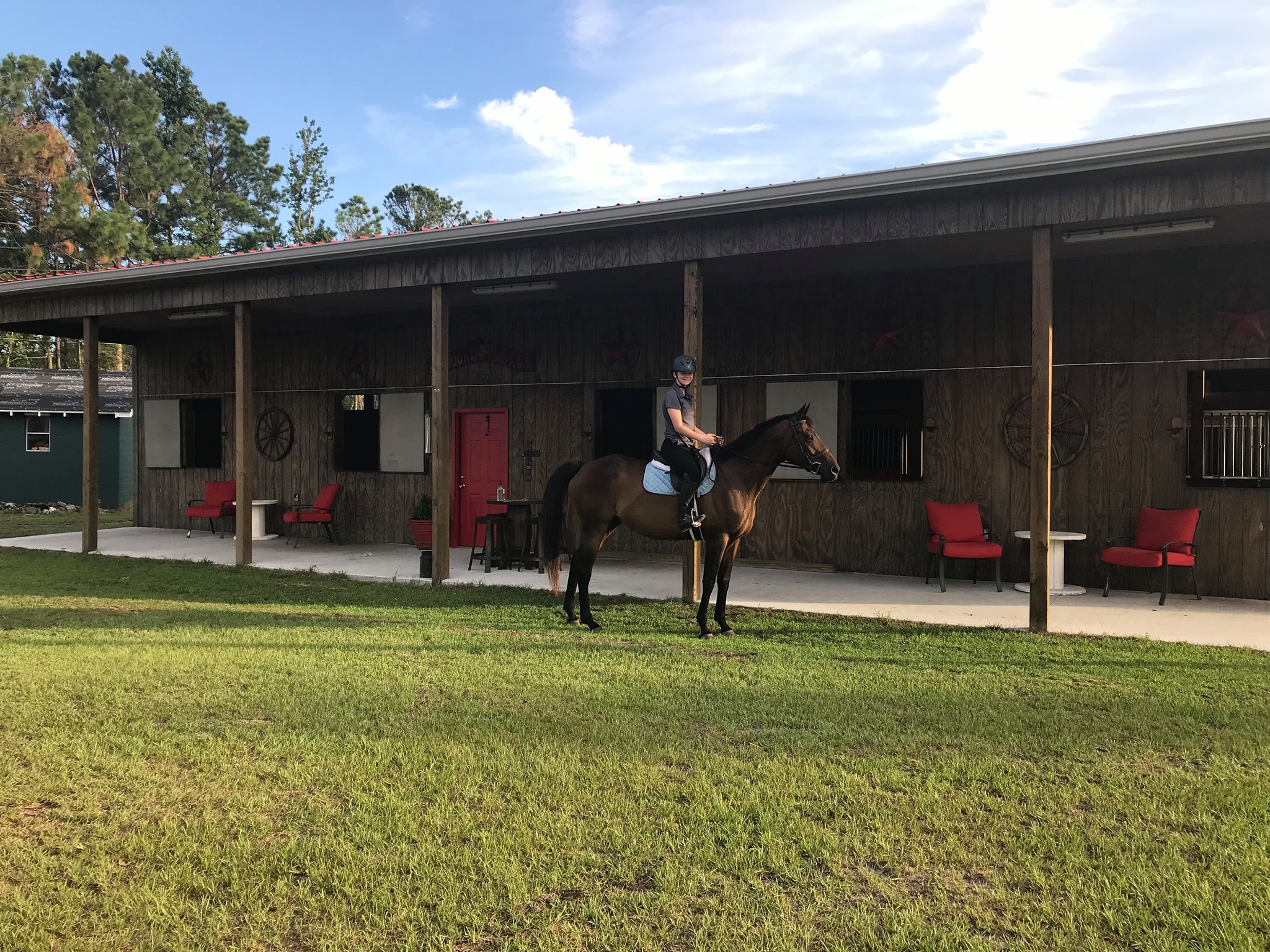 The barn exterior with covered porch and seating